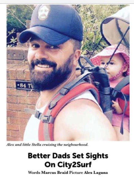 Newspaper photo of Alex with his daughter Stella in a carrier, ahead of the 2015 City2Surf